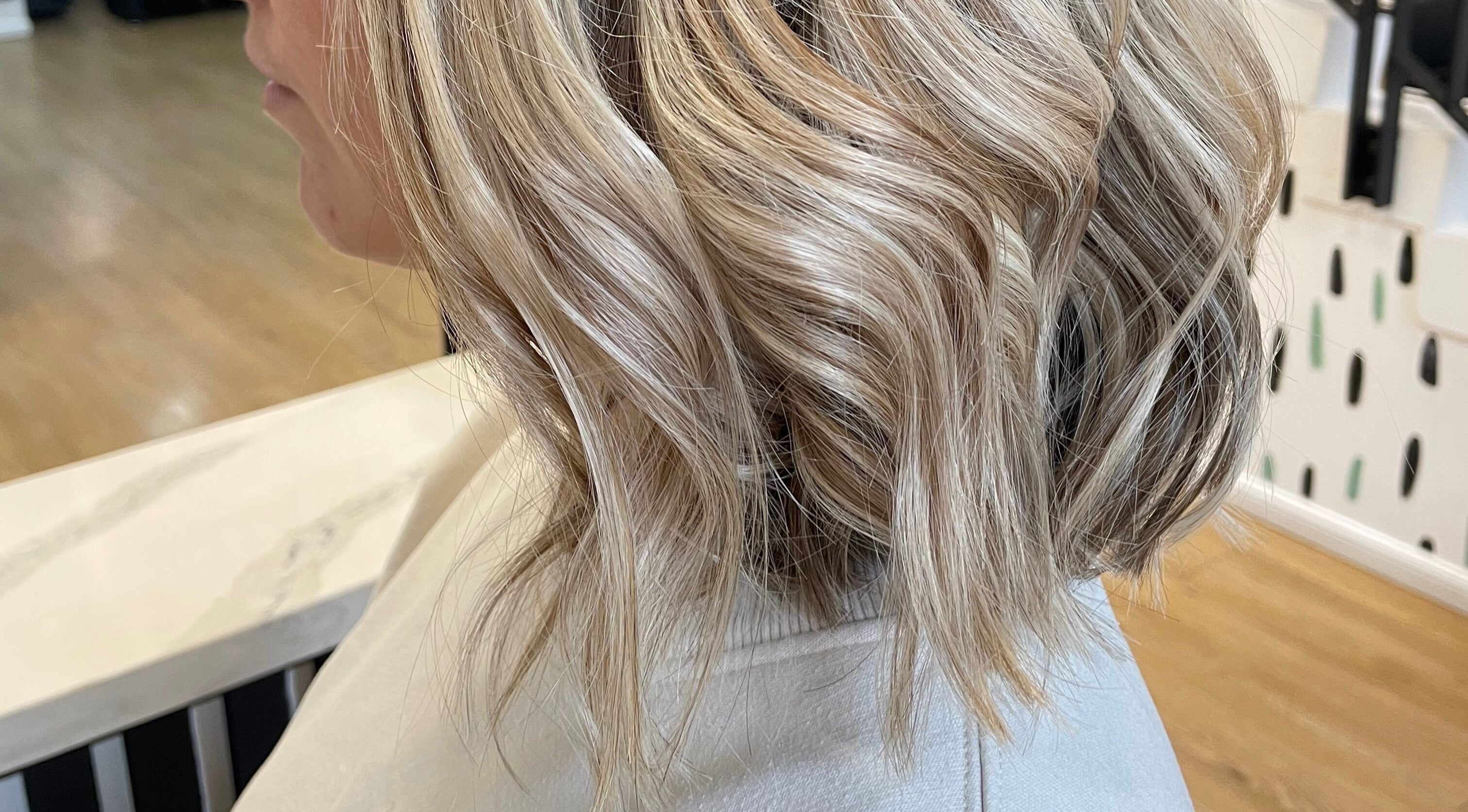 Chloe Mitchell Hair in Glasgow, Scotland, GB showcases elegant blonde curls in a chic bob style.