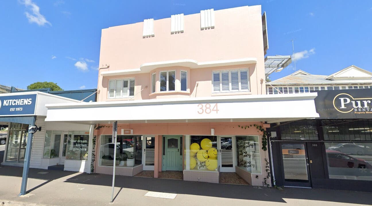 Exterior of Studio T at 384 Windsor, Queensland, AU, showcasing a pink facade and welcoming atmosphere.