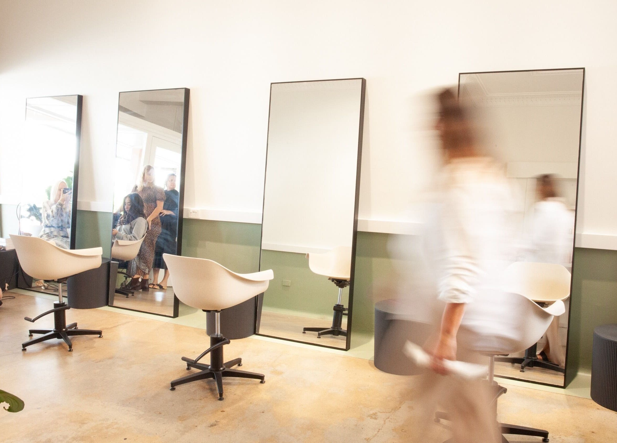 Modern salon interior at Studio T in Windsor, Queensland, AU with stylish chairs and mirrors.