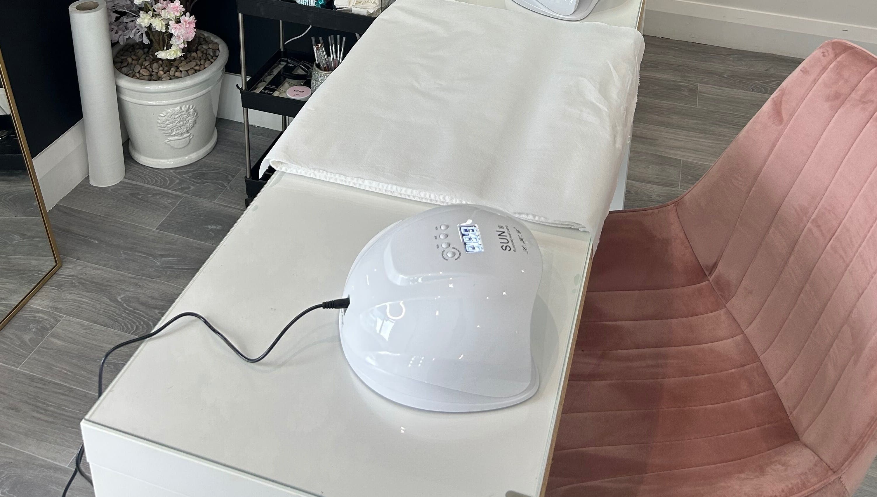 Allure Beauty | By Ash nail station in Carrick-on-Shannon, County Leitrim, IE, featuring a SUN nail lamp and plush chair.