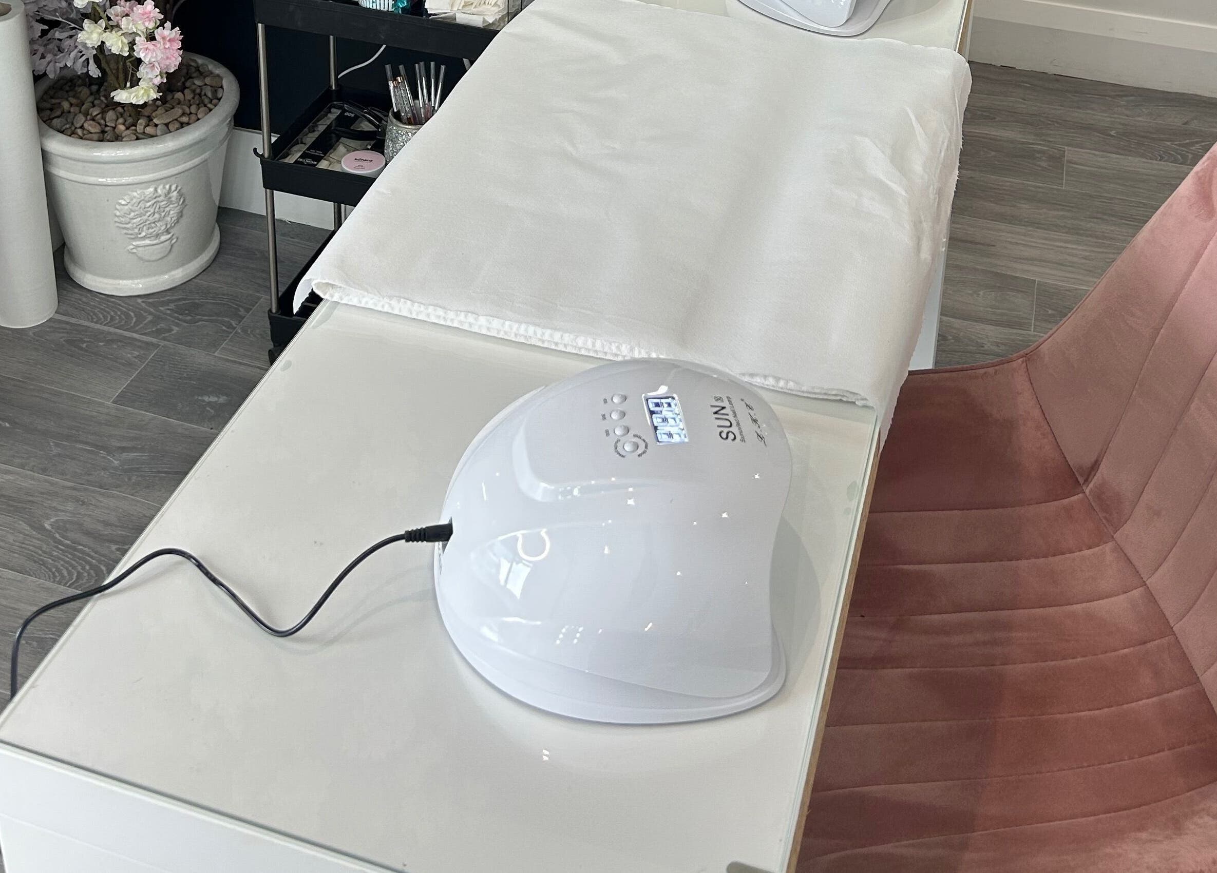 Allure Beauty | By Ash nail station in Carrick-on-Shannon, County Leitrim, IE, featuring a SUN nail lamp and plush chair.