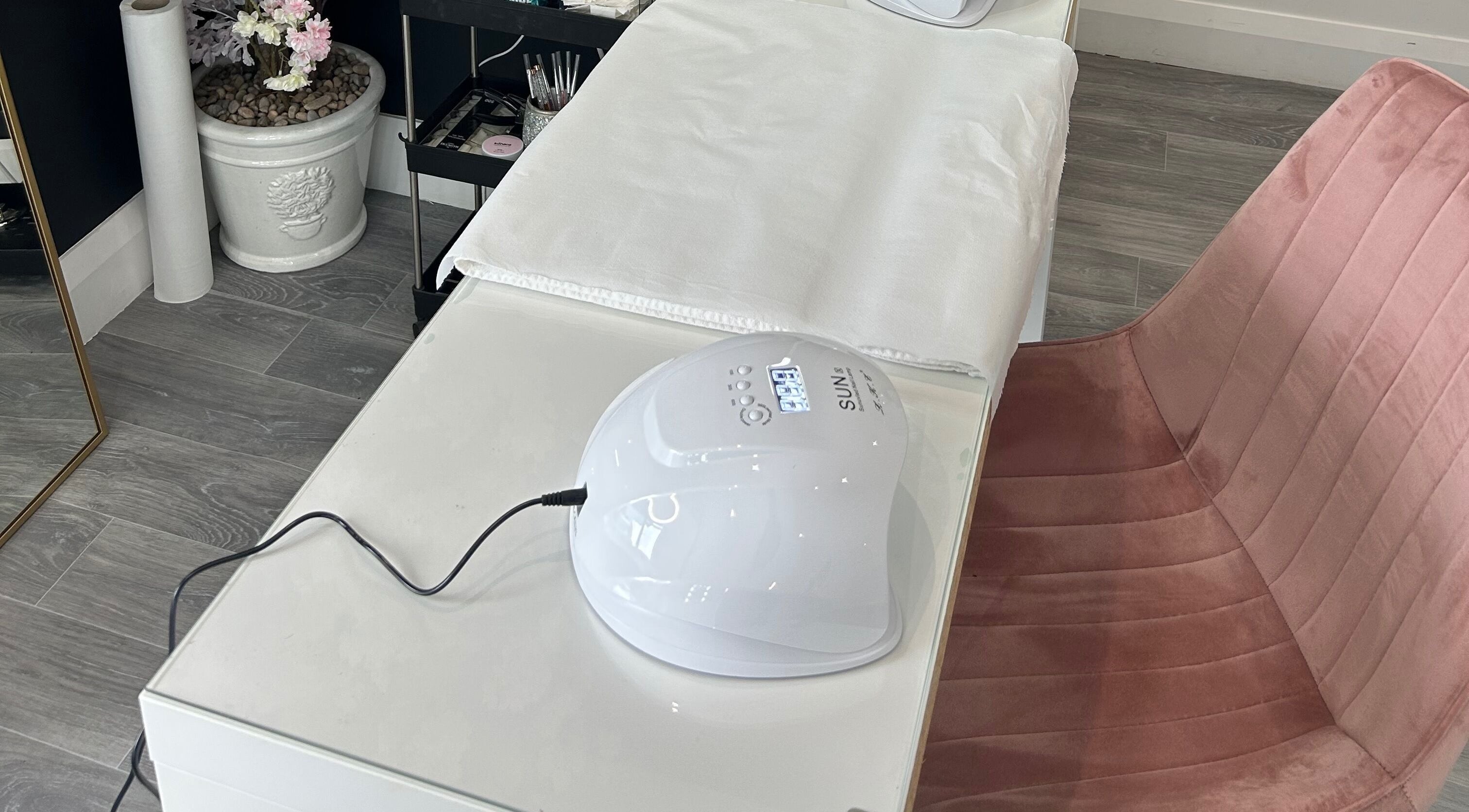 Allure Beauty | By Ash nail station in Carrick-on-Shannon, County Leitrim, IE, featuring a SUN nail lamp and plush chair.