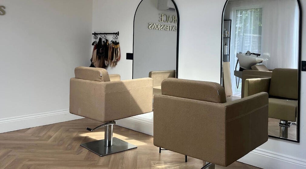 Interior of Grace Hair Extensions salon in Portsmouth, England, GB, featuring stylish chairs and mirrors.
