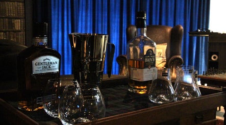 Sophisticated whiskey lounge at The Male Room, East London, Eastern Cape, ZA, showcasing premium bottles and glasses.