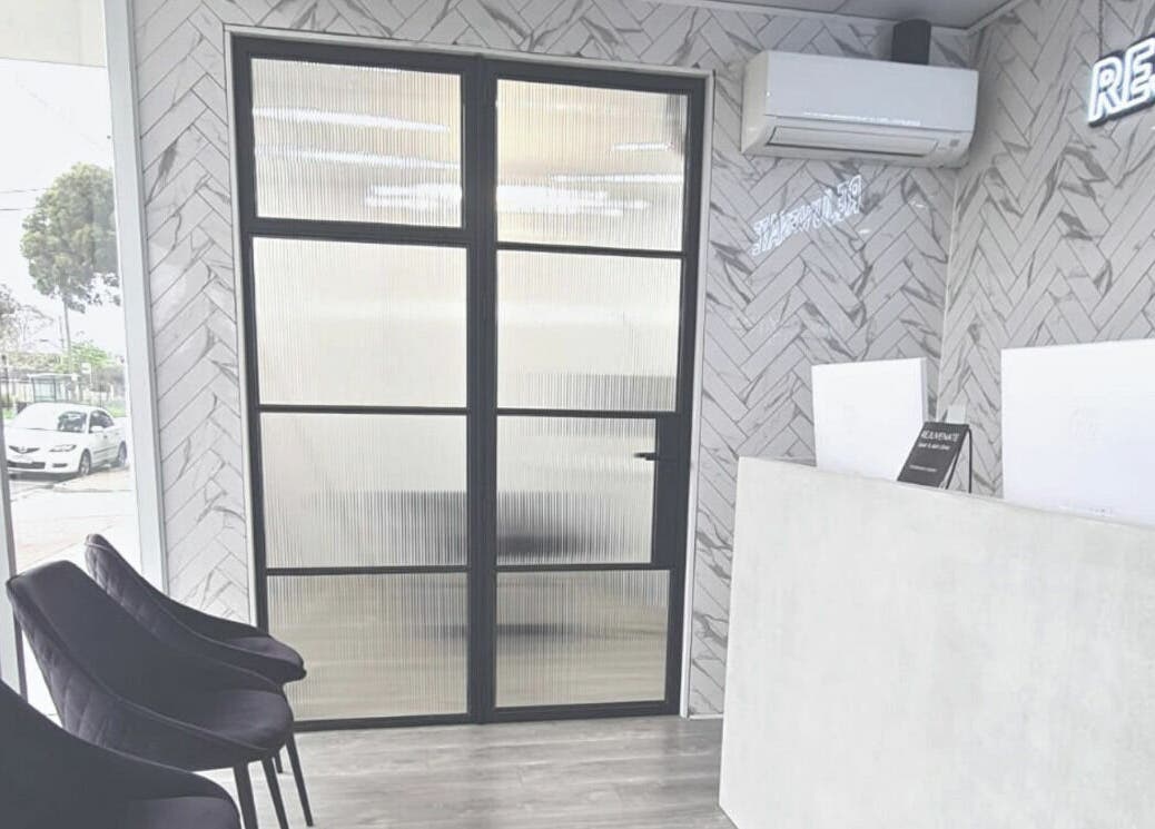 Modern reception area at Rejuvenate Laser & Skin Clinic, Pascoe Vale, VIC, AU with stylish chairs and herringbone tiles.