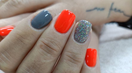 Colorful manicure at Salon ES, Pretoria, Gauteng, ZA featuring orange, grey, and glitter nails.