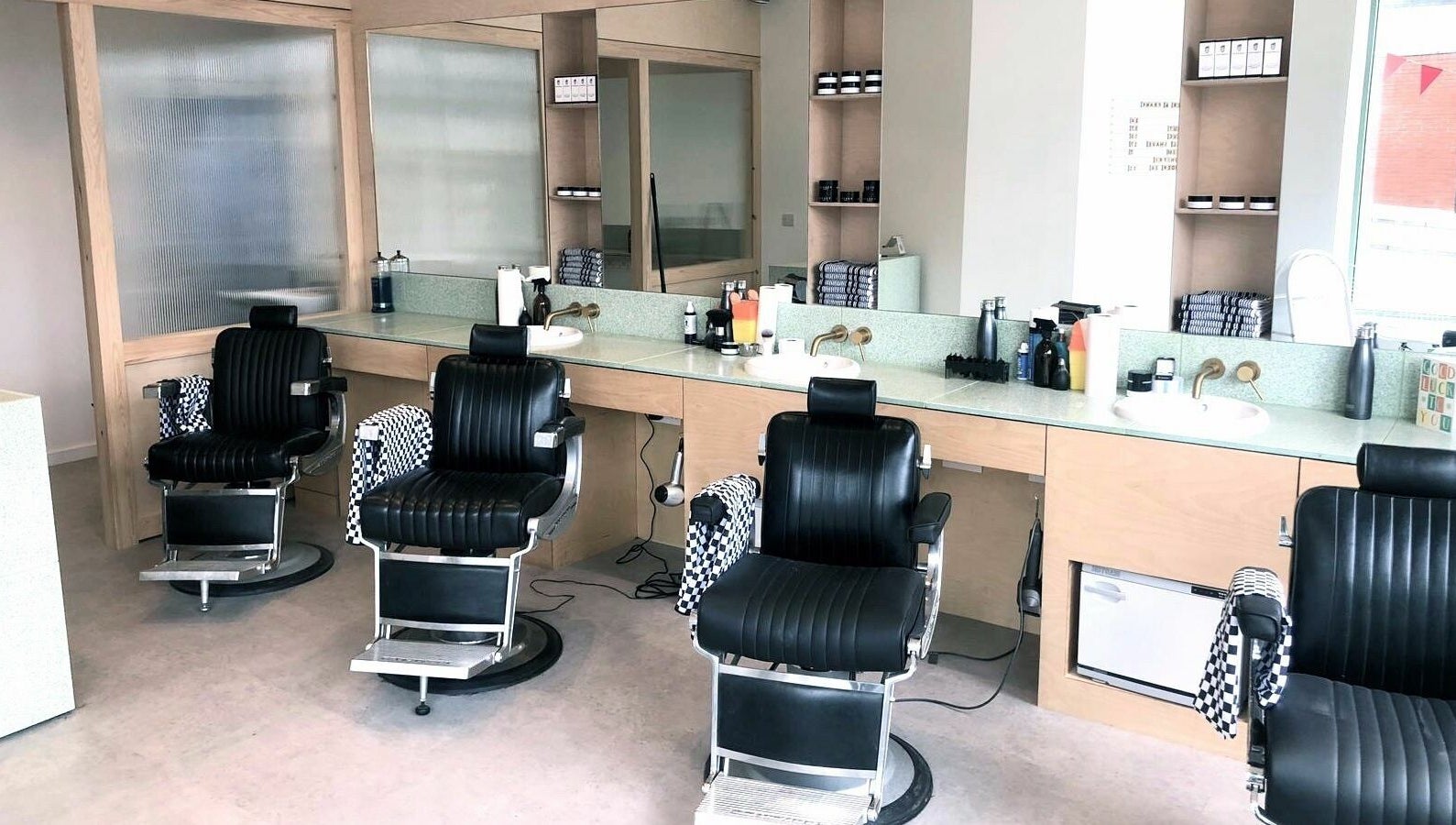 Modern barber chairs at Barber and Frank Kemptown, Brighton, England, GB showcasing a stylish interior.