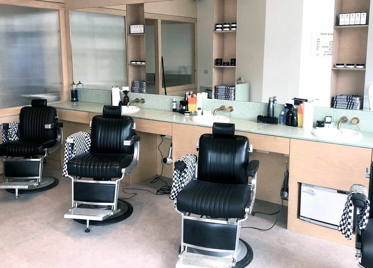 Modern barber chairs at Barber and Frank Kemptown, Brighton, England, GB showcasing a stylish interior.