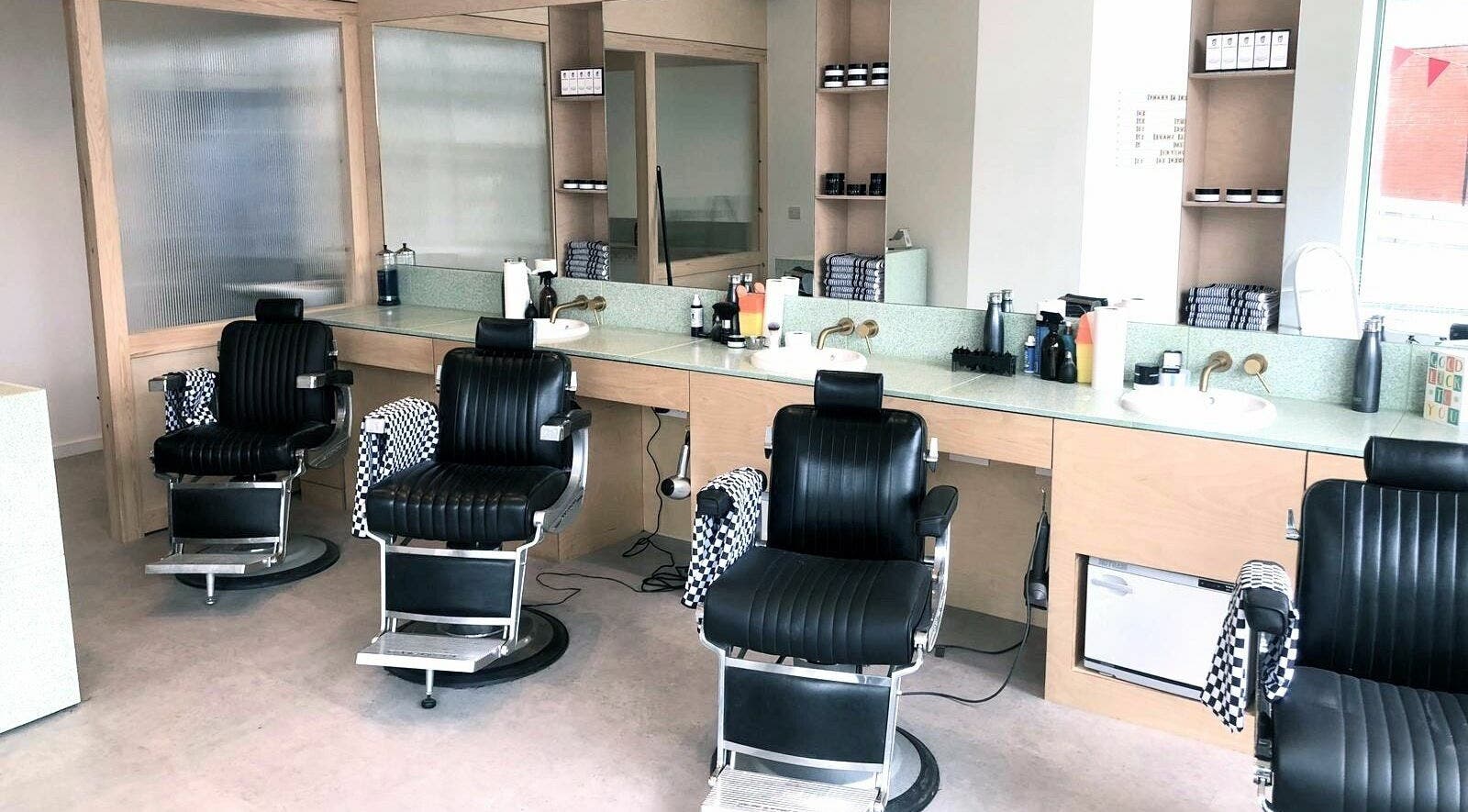 Modern barber chairs at Barber and Frank Kemptown, Brighton, England, GB showcasing a stylish interior.