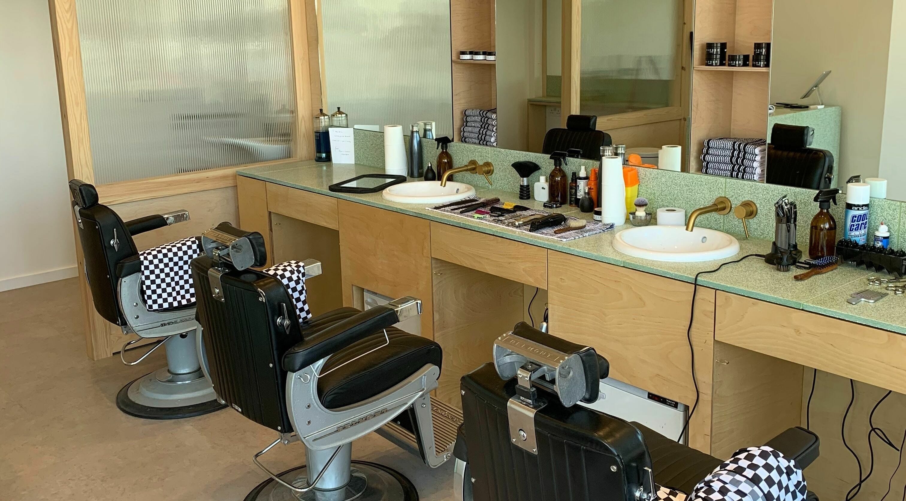 Modern barber chairs at Barber and Frank Kemptown in Brighton, England, GB, with tools neatly arranged.