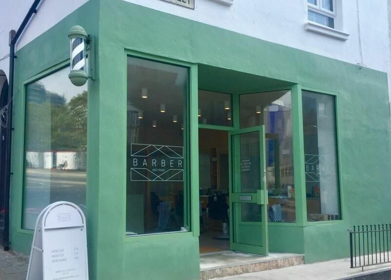 Front view of Barber and Frank Kemptown, green facade in Brighton, England, GB.