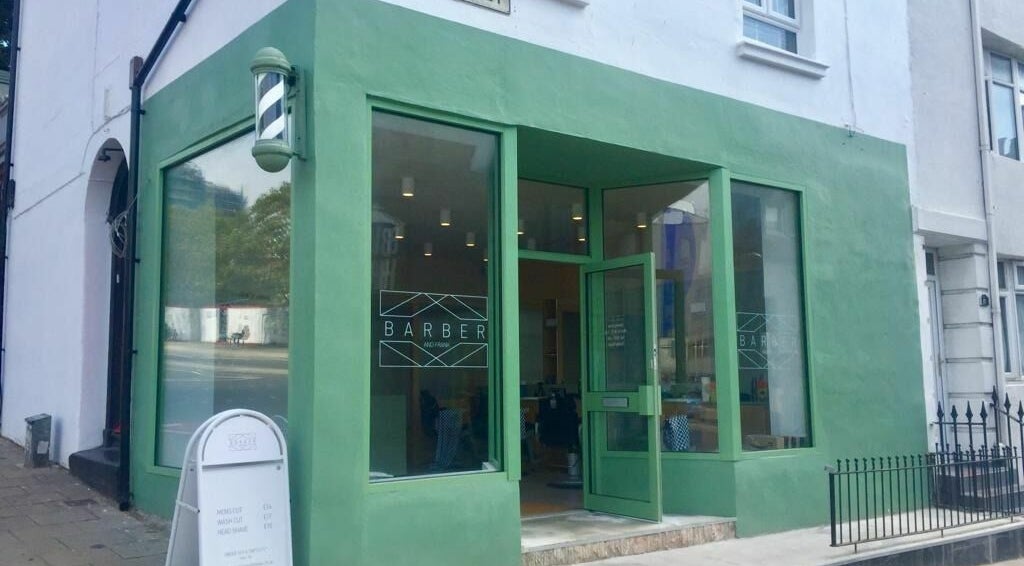 Front view of Barber and Frank Kemptown, green facade in Brighton, England, GB.