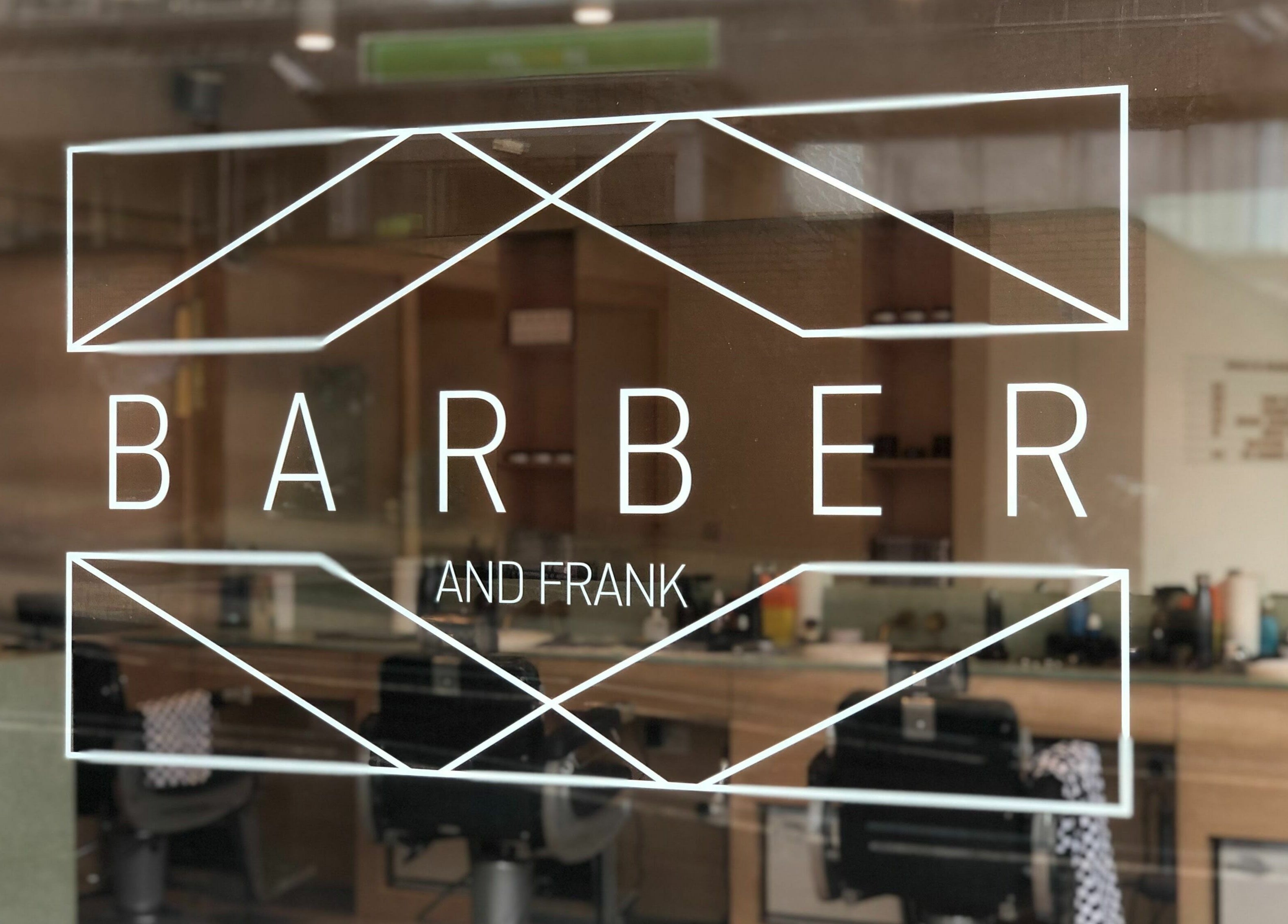 Elegant storefront of Barber and Frank Kemptown in Brighton, England, GB with modern interior.