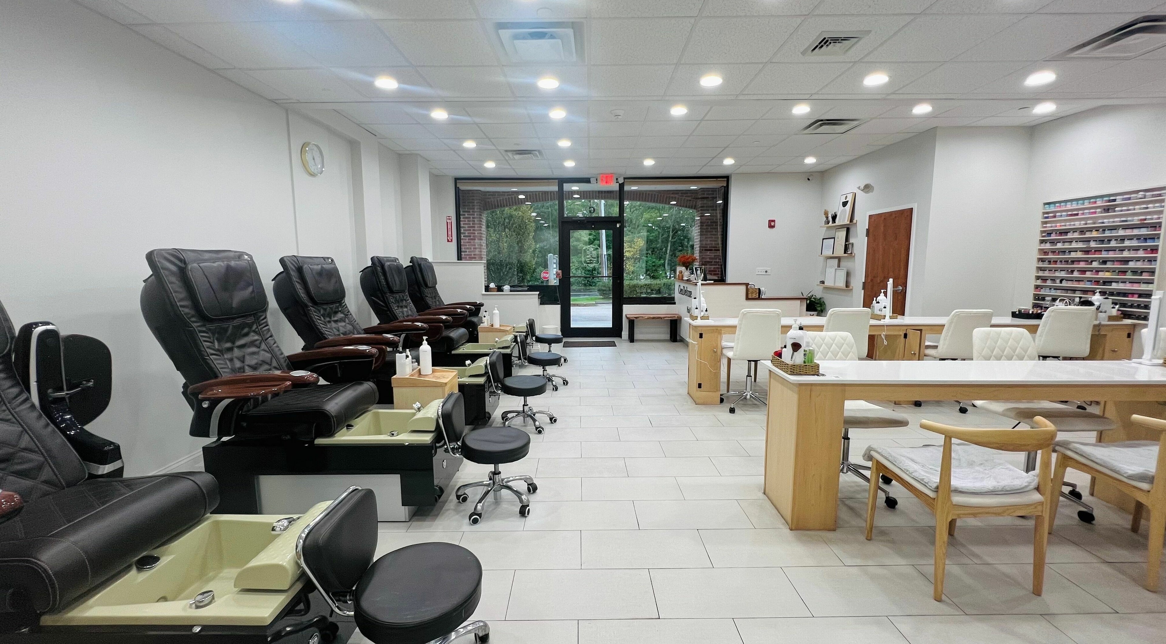 Interior view of CenDeluxe Nail Spa in Natick, Massachusetts, US showcasing modern manicure and pedicure stations.