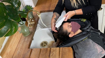 Client enjoys a hair wash at B Yo Uty Hair and Beauty Mobile Service in London, England, GB.