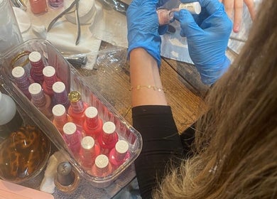 Nail technician applying polish at B Yo Uty Hair and Beauty Mobile Service, London, England, GB.