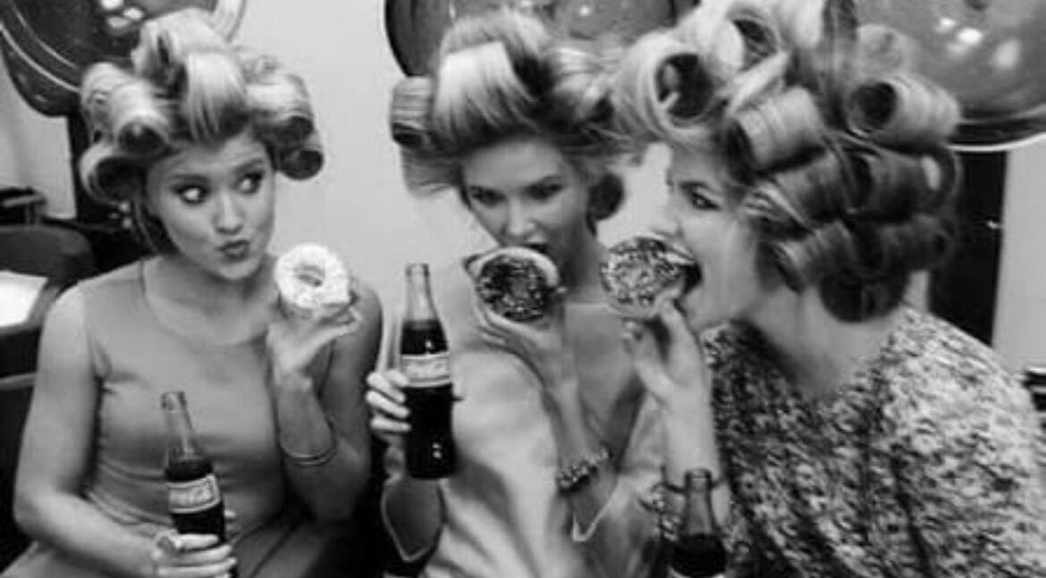 Women with vintage hairstyles savor donuts at B Yo Uty Hair and Beauty Mobile Service, London, England, GB.