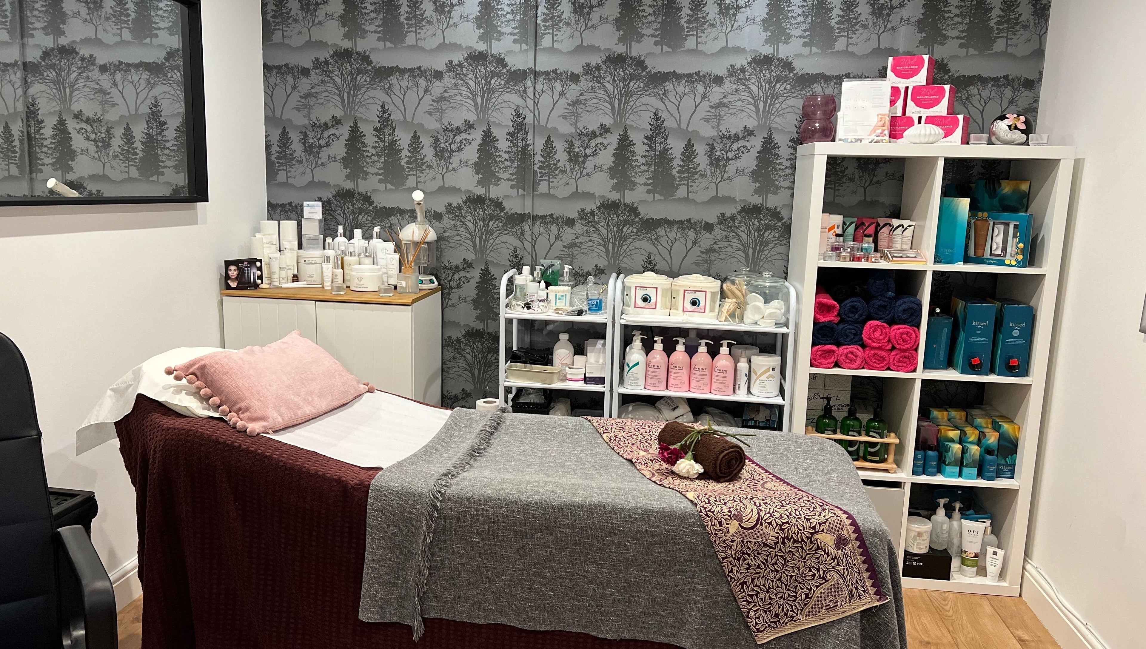 A serene spa room at Archfit Beauty by Rabia Ehsan in Birmingham, England, GB with a treatment bed and beauty products.