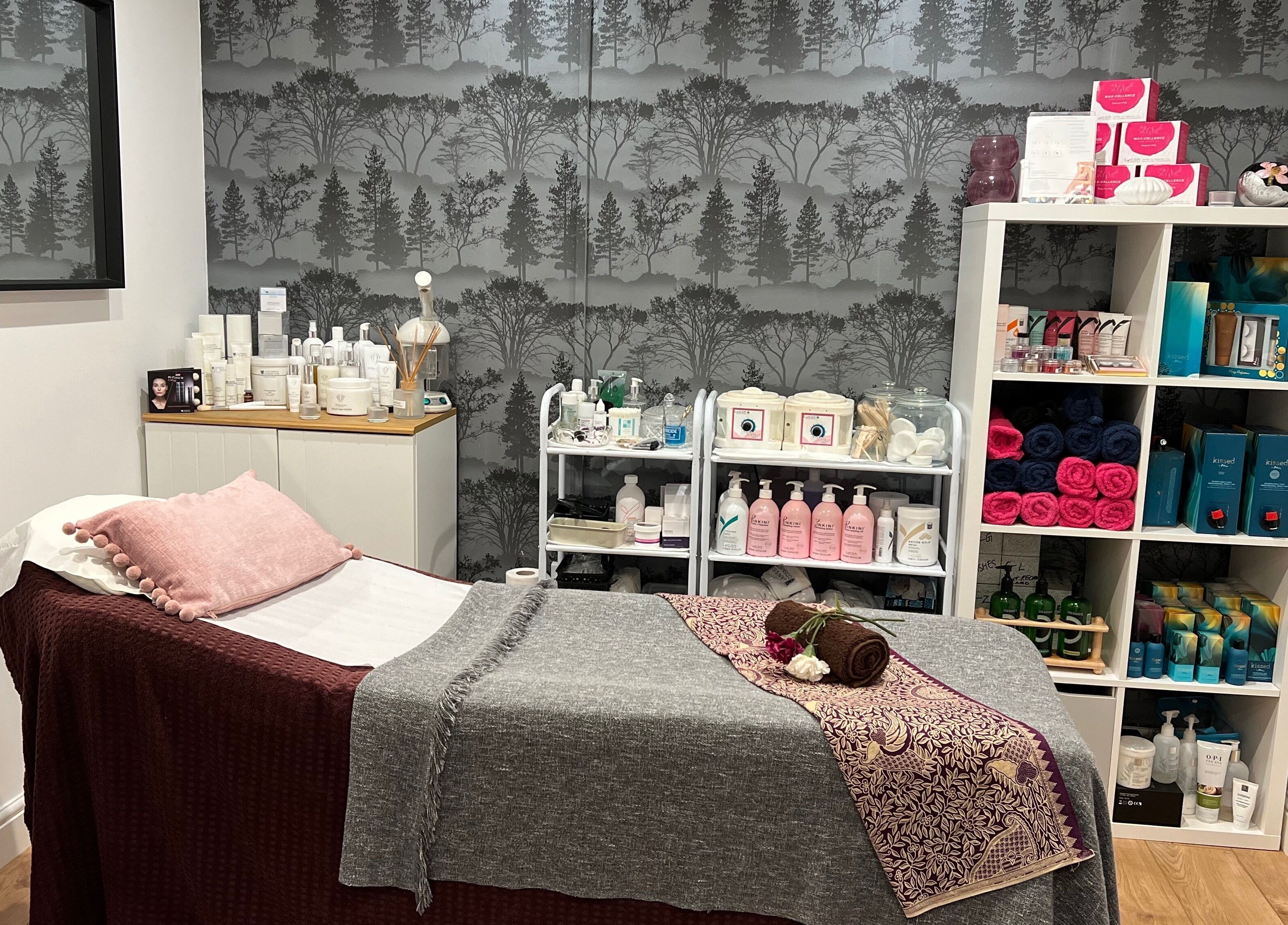 A serene spa room at Archfit Beauty by Rabia Ehsan in Birmingham, England, GB with a treatment bed and beauty products.