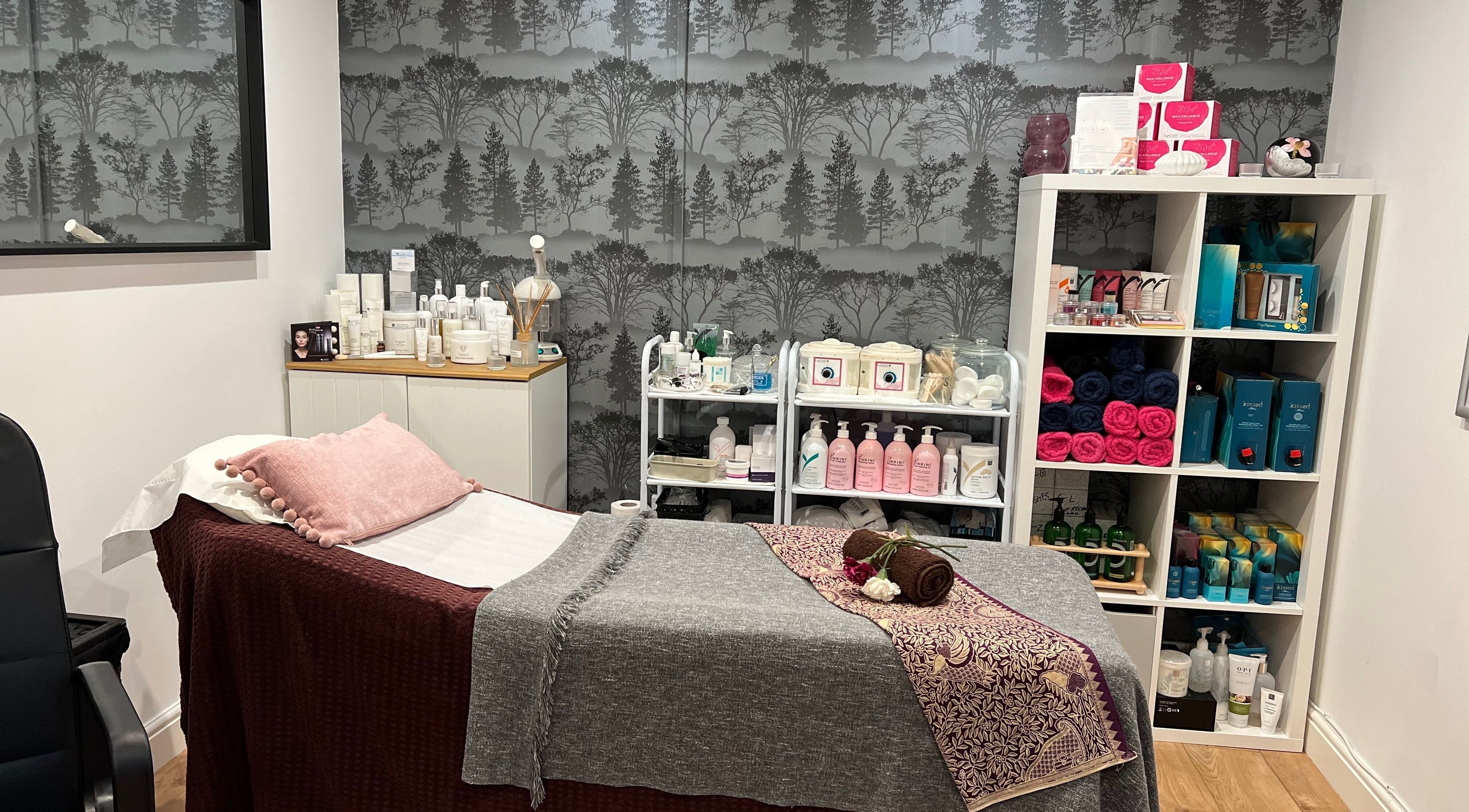 A serene spa room at Archfit Beauty by Rabia Ehsan in Birmingham, England, GB with a treatment bed and beauty products.