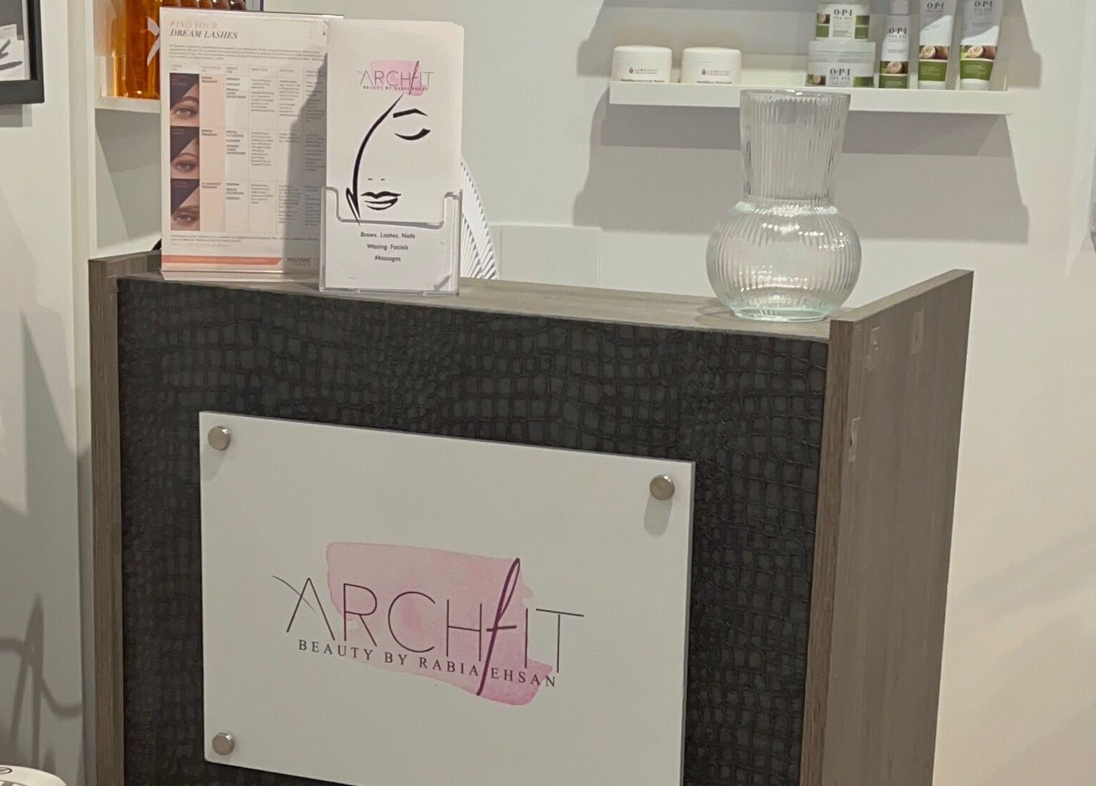 Reception desk at Archfit Beauty by Rabia Ehsan, showcasing services menu and decor in Birmingham, England, GB.