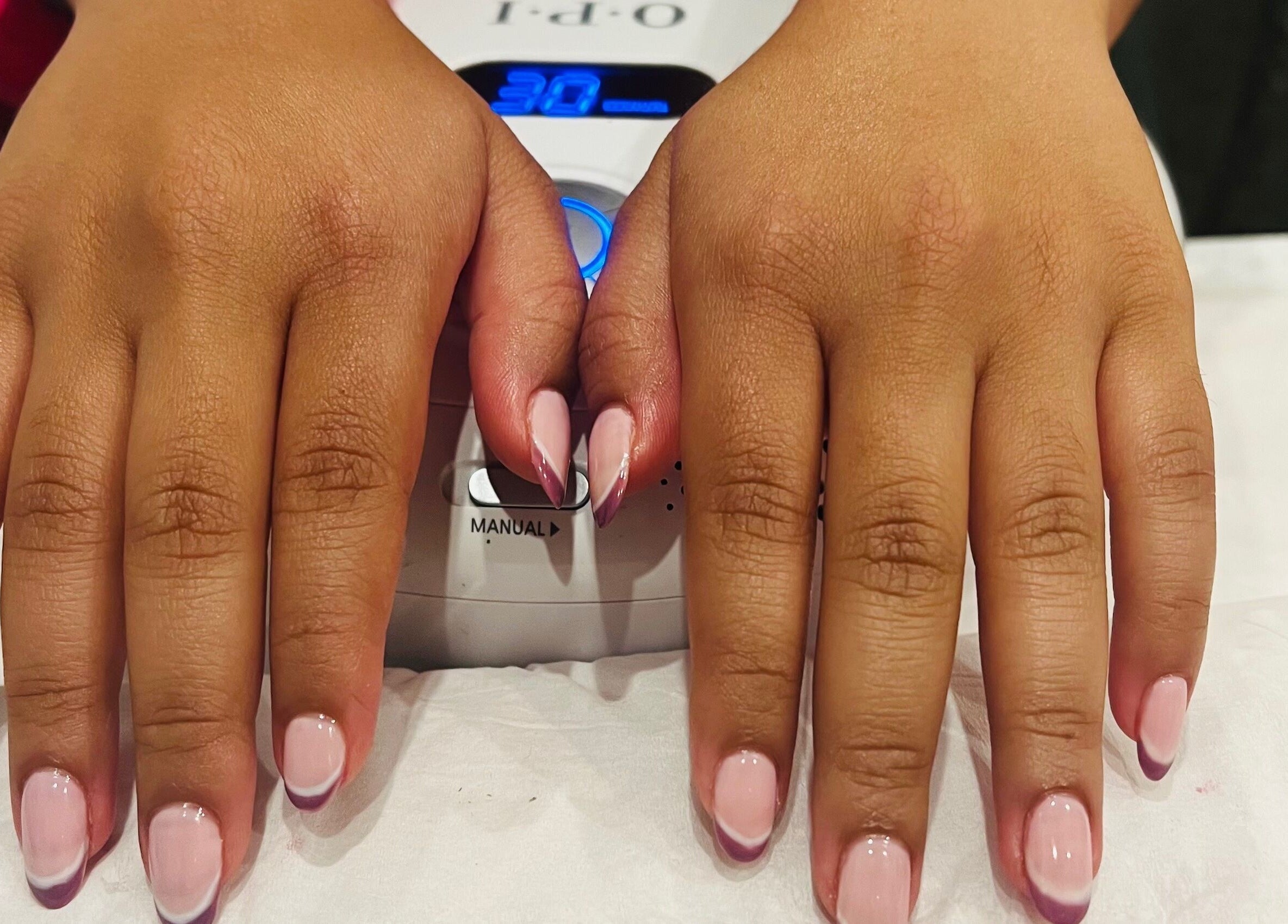 Manicured hands with pink and purple nails at Archfit Beauty by Rabia Ehsan, Birmingham, England, GB.