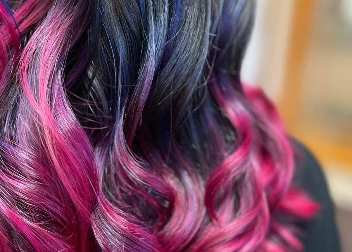 Vibrant pink and purple hair coloring at Studio 815, Genoa, Illinois, US. Expert salon styling.