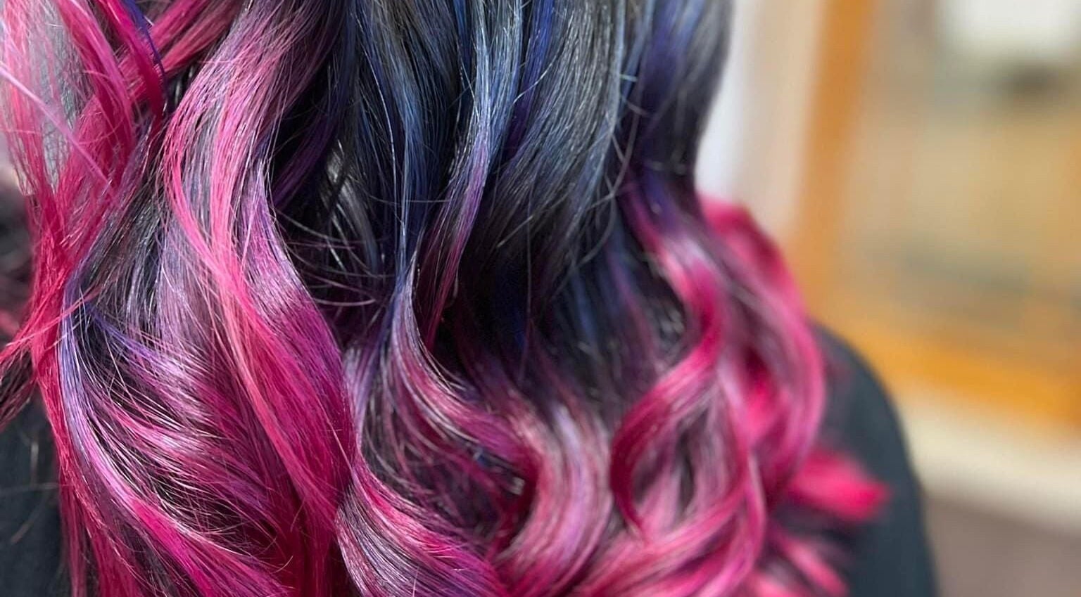 Vibrant pink and purple hair coloring at Studio 815, Genoa, Illinois, US. Expert salon styling.