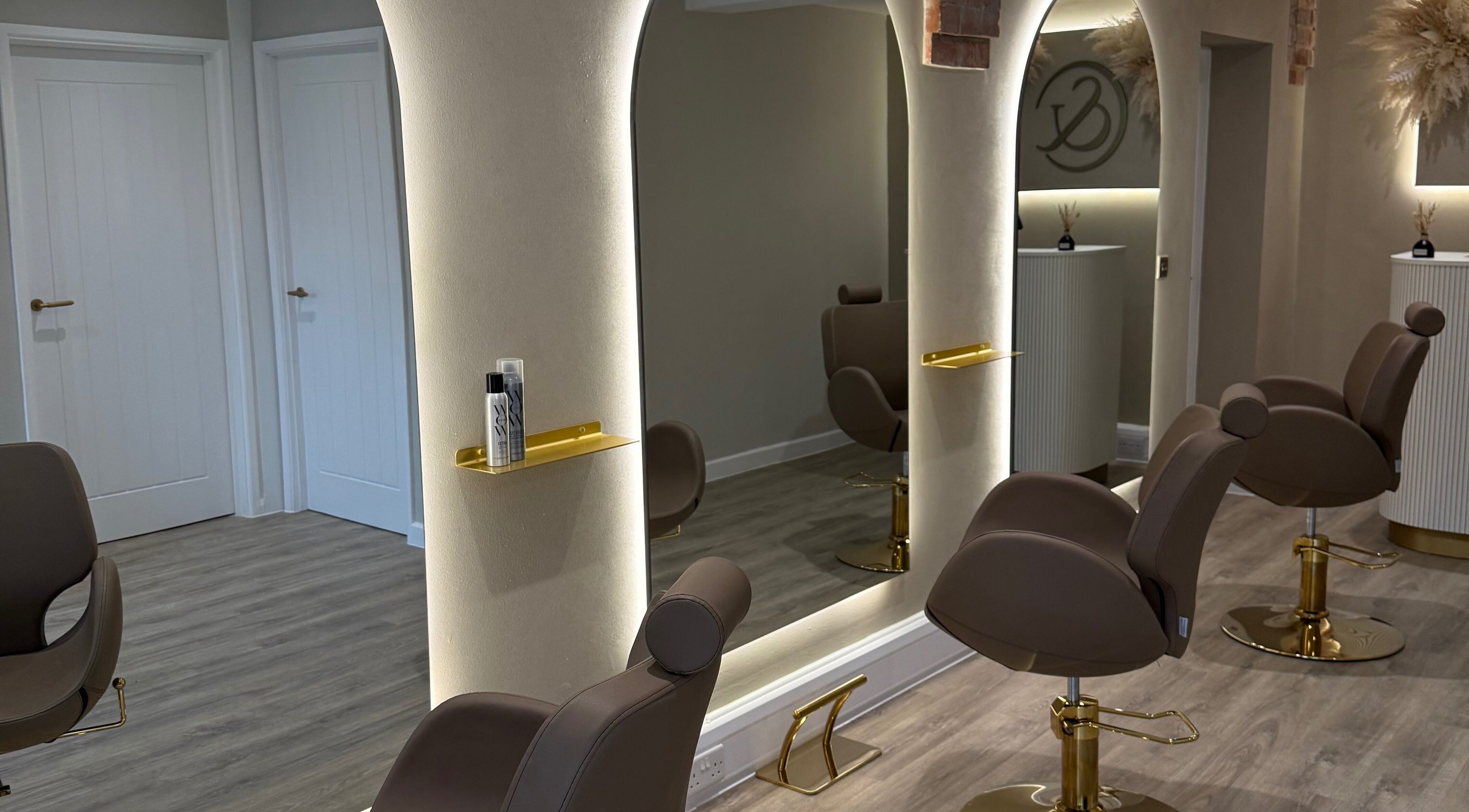 Modern salon chairs and large mirrors at C Rihanna Hair, Northampton, England, GB.