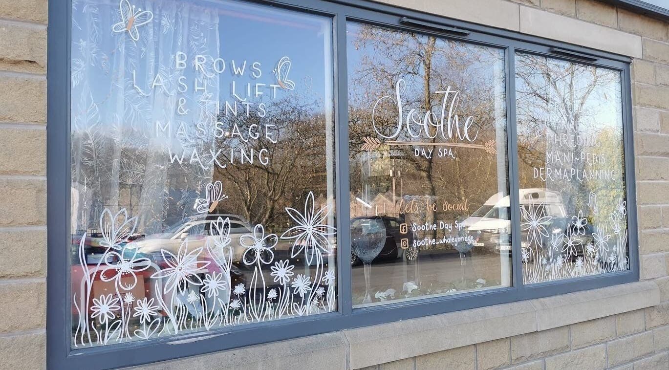 Soothe Day Spa window with floral design at Whaley Bridge, England, GB offering massages and waxing.