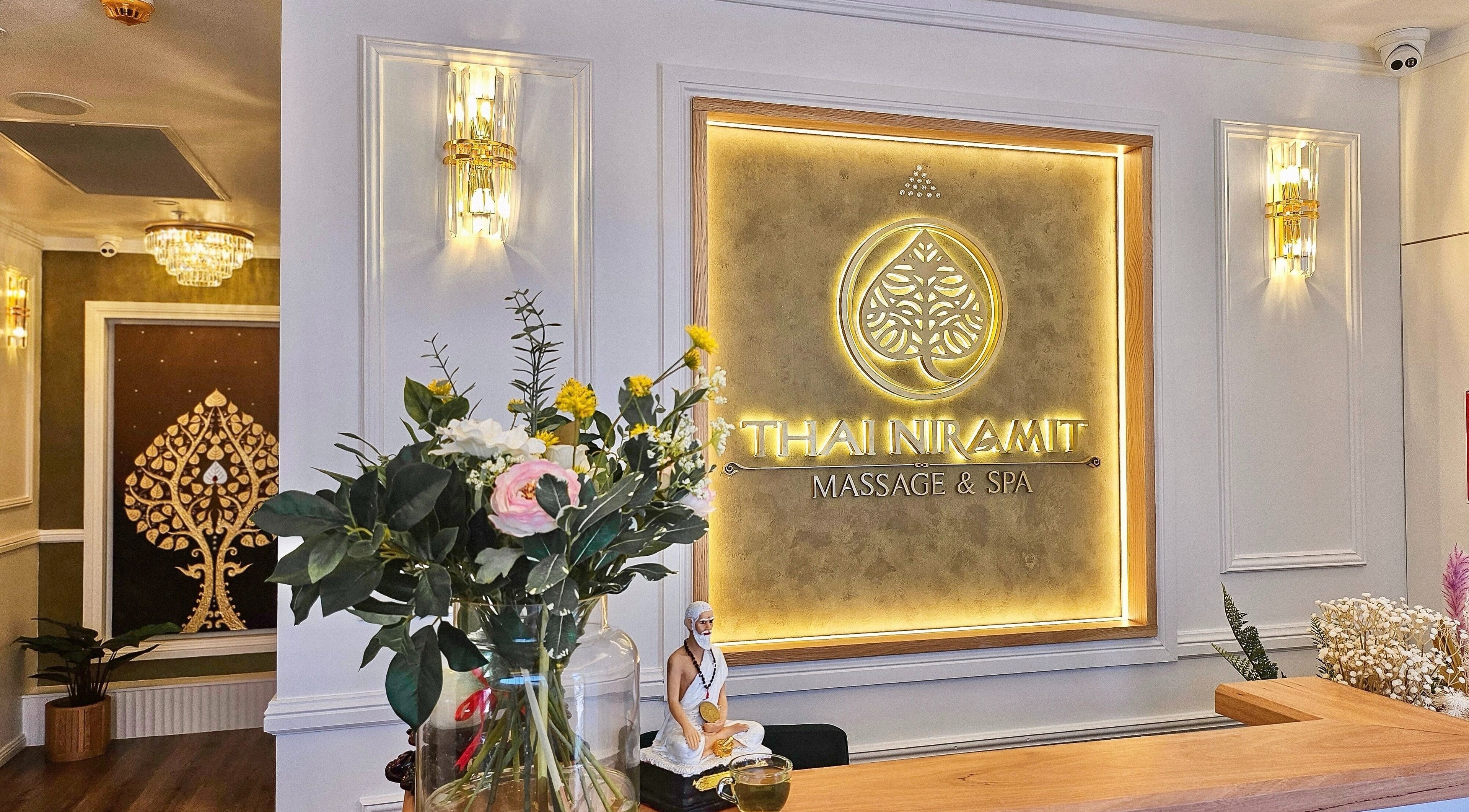 Elegant lit signage at Vaughan St. Branch - Thai Niramit Massage and Spa in Lidcombe, NSW, AU with flowers and decor.