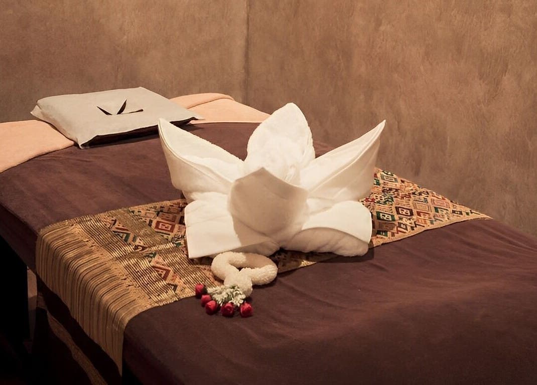 Massage bed at Vaughan St. Branch - Thai Niramit Massage and Spa, Lidcombe, NSW, AU adorned with towels.