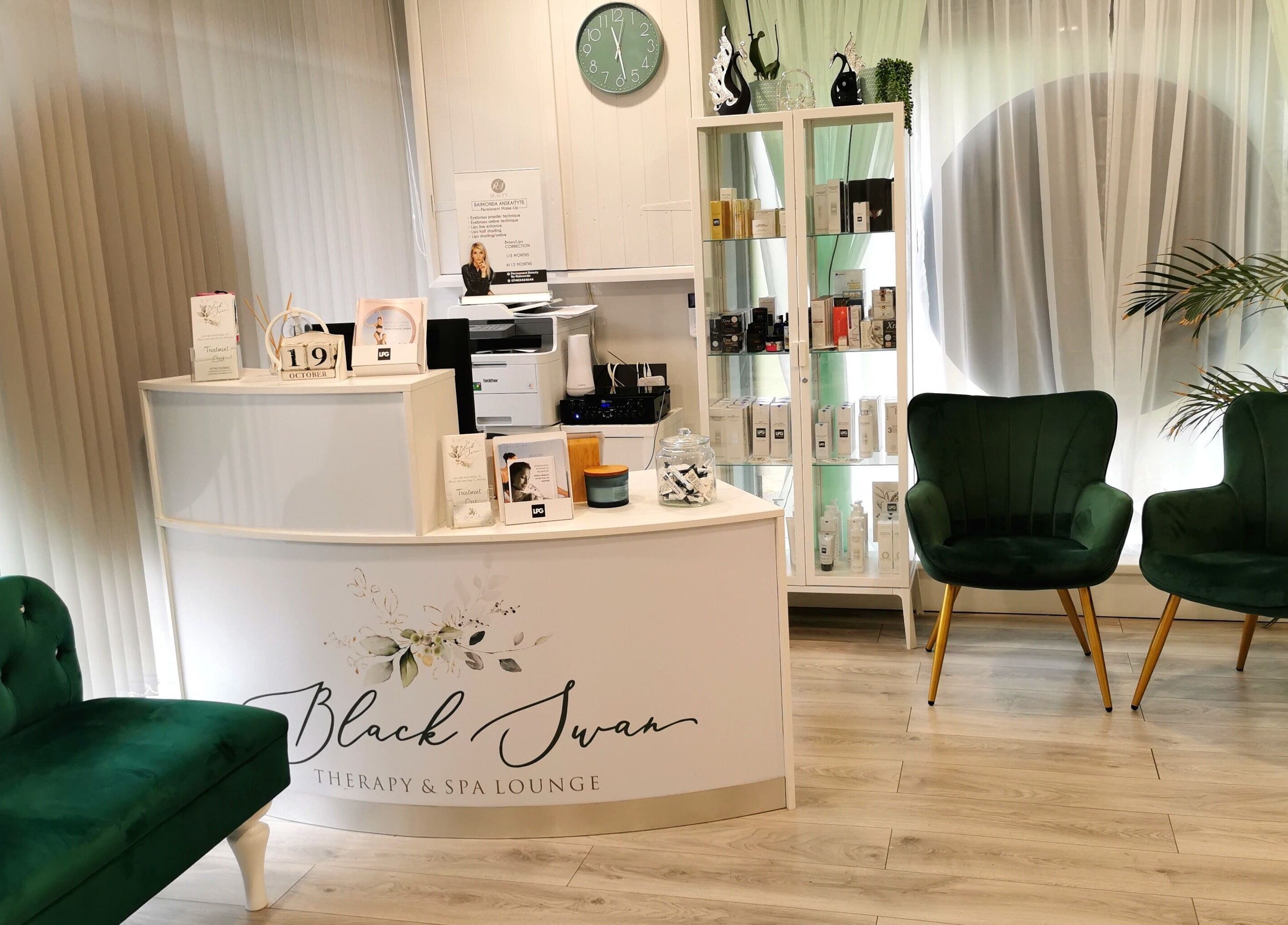 Inviting reception area of Black Swan Therapy & Spa Lounge, Bognor Regis, England, GB with elegant green chairs and decor.