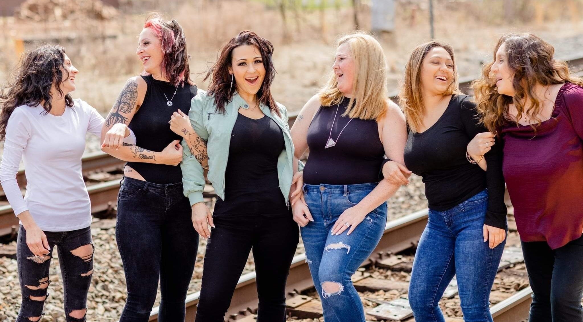 Group of smiling women at Radiant Beauty Studio, Culpeper, Virginia, US enjoying a sunny day.