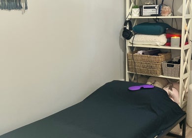 Relaxing therapy room at Altruistic Alternative Therapies, Muckatah, Victoria, AU with a cozy bed and shelves.