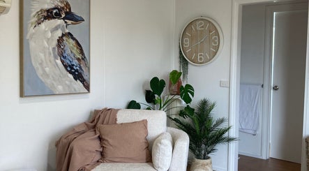 Cozy lounge at Altruistic Alternative Therapies, Muckatah, Victoria, AU with plants and art decor.