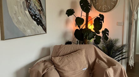 Relaxing corner at Altruistic Alternative Therapies, Muckatah, Victoria, AU, featuring plush chair and plants.