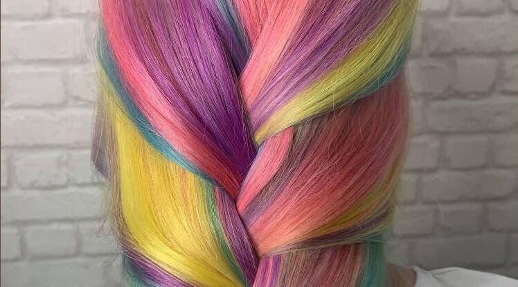 Vibrant rainbow braid hairstyle at Amber Elizabeth Hairdressing, Greenock, Scotland, GB.