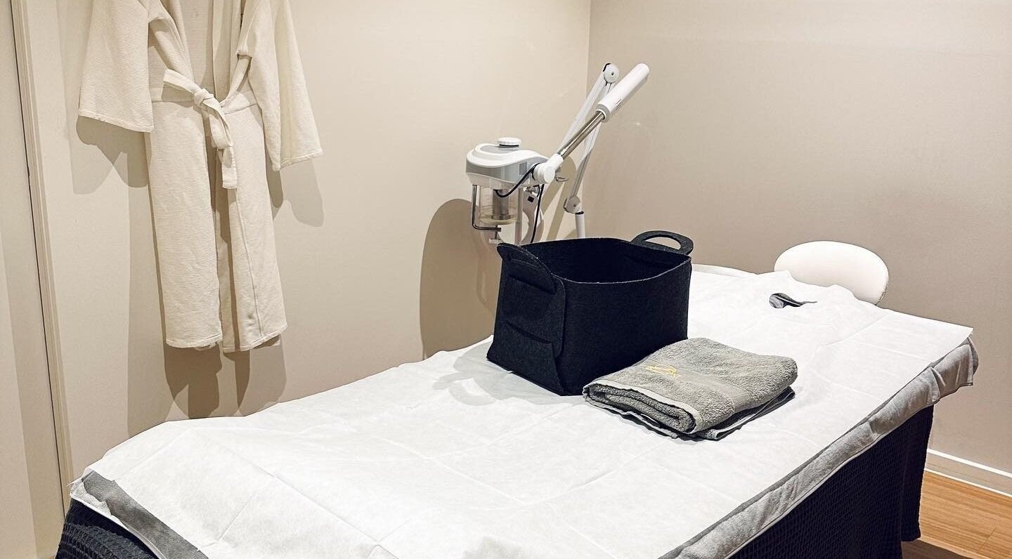 Tranquil treatment room at Five Elements Spa, South Melbourne, Victoria, AU with massage bed and bathrobe.