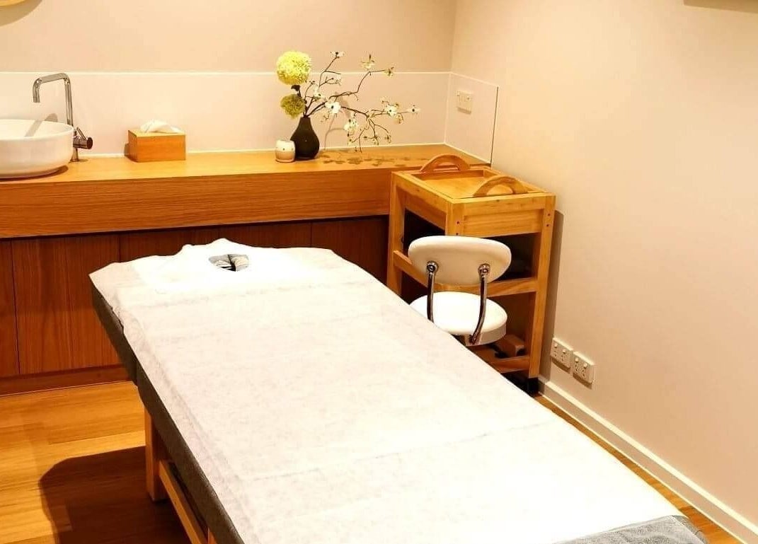 Cozy massage room at Five Elements Spa, South Melbourne, Victoria, AU featuring a relaxation bed and minimalist decor.