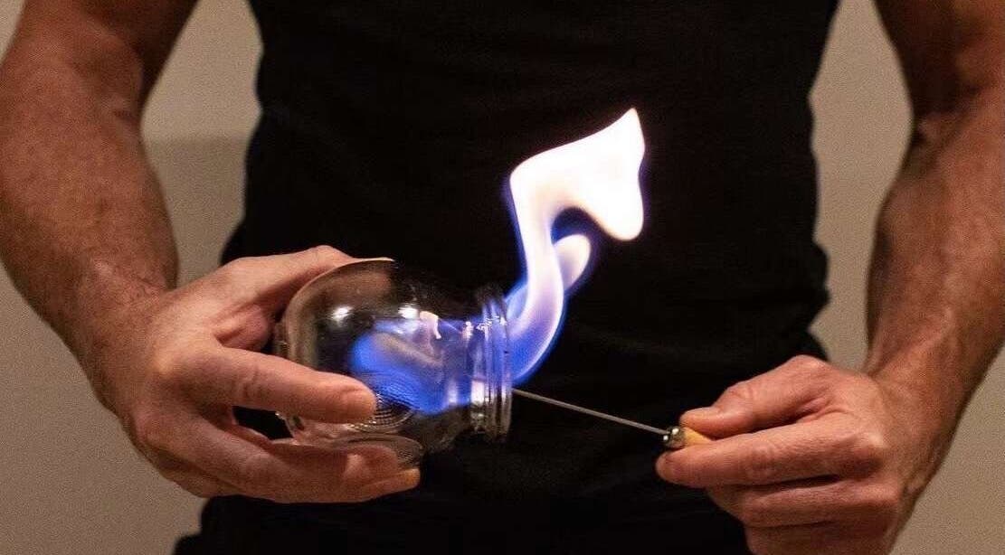 Therapist at Five Elements Spa CBD in Melbourne, Victoria, AU performs cupping therapy with flame for relaxation.