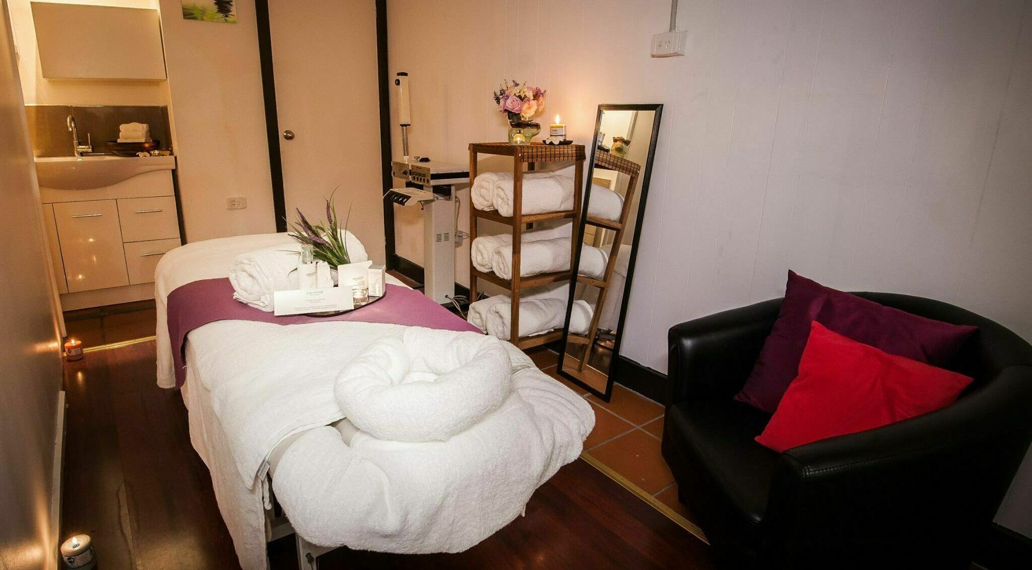 Relaxing massage room at Body Retreat in Melbourne, Victoria, AU with soft lighting and a cozy setup.