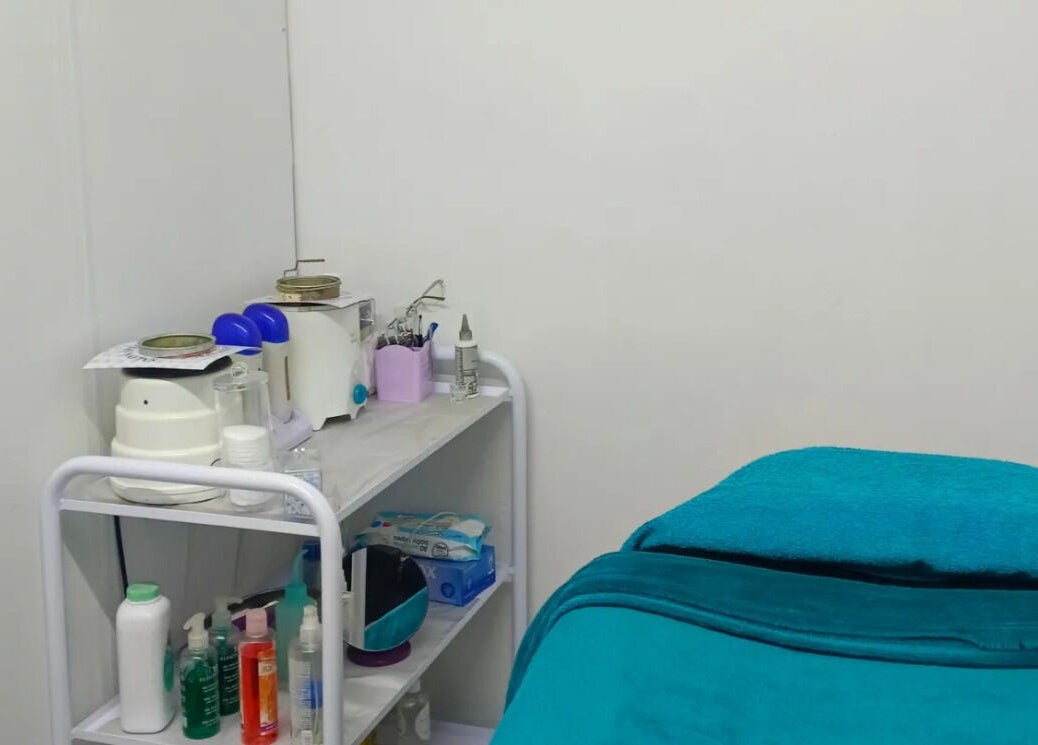 Cozy treatment room at Dare 2B Beautiful, Boksburg, Gauteng, ZA featuring treatment bed and skincare supplies.