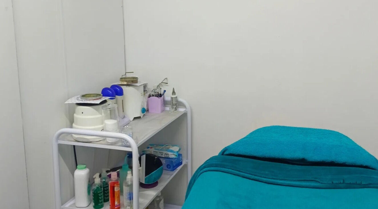 Cozy treatment room at Dare 2B Beautiful, Boksburg, Gauteng, ZA featuring treatment bed and skincare supplies.