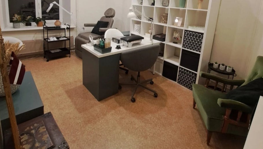 Cozy manicure station at Nails & Pearls Manikīra studija, Rīga, LV, featuring a chair and work desk.