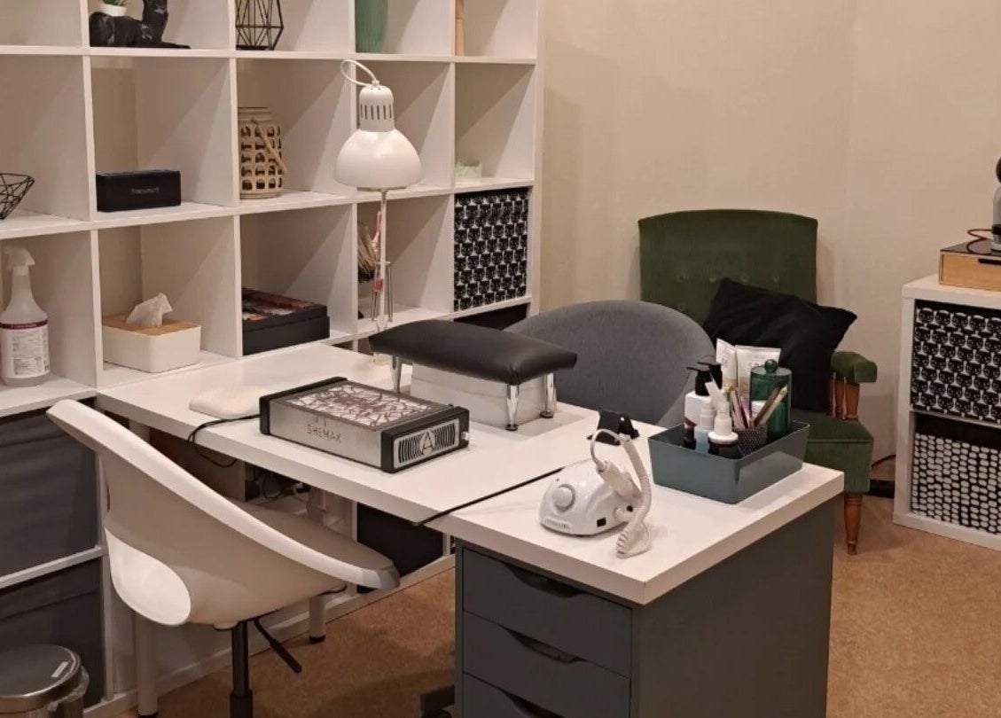 Comfortable nail salon station at Nails & Pearls Manikīra studija, Rīga, LV, featuring tools and seating.