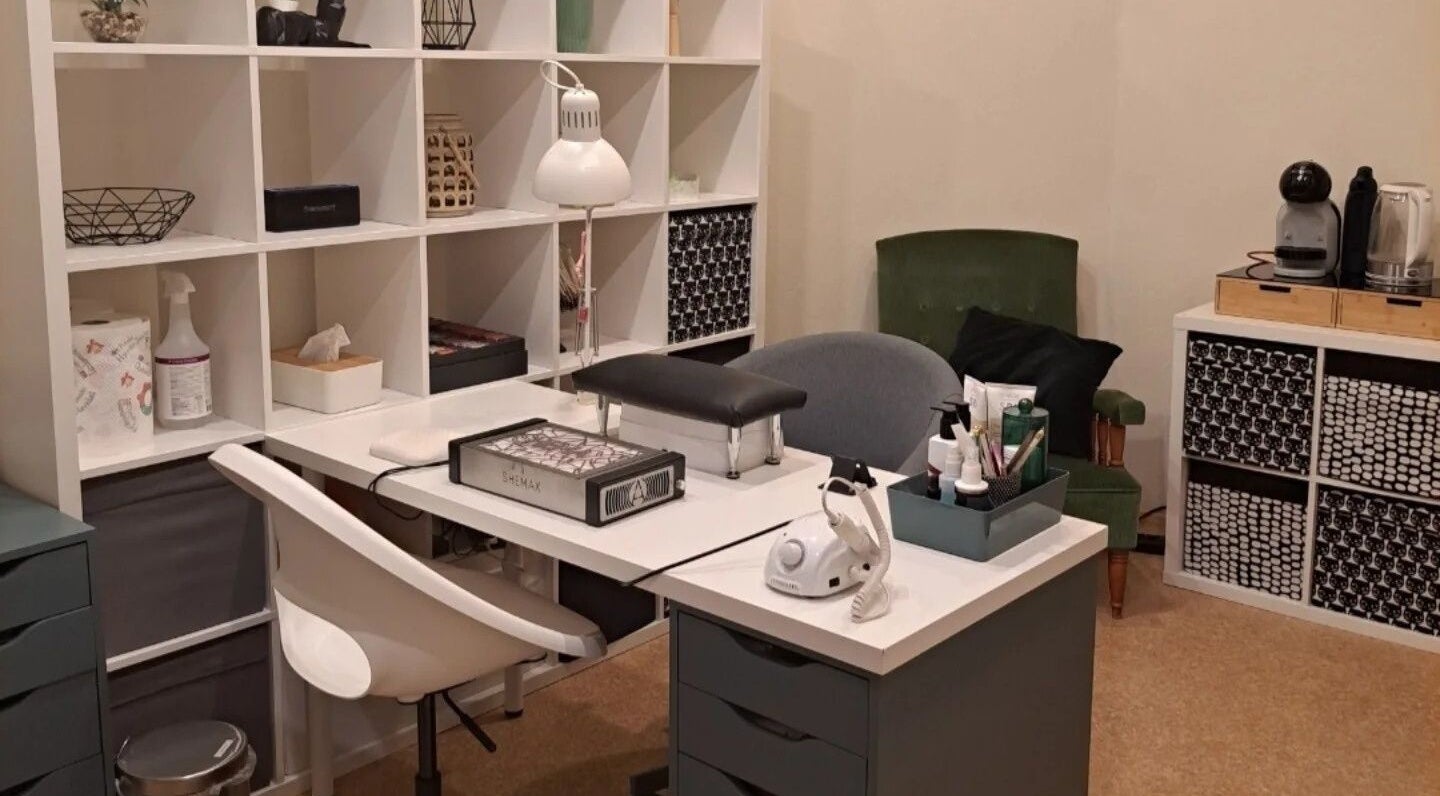 Comfortable nail salon station at Nails & Pearls Manikīra studija, Rīga, LV, featuring tools and seating.