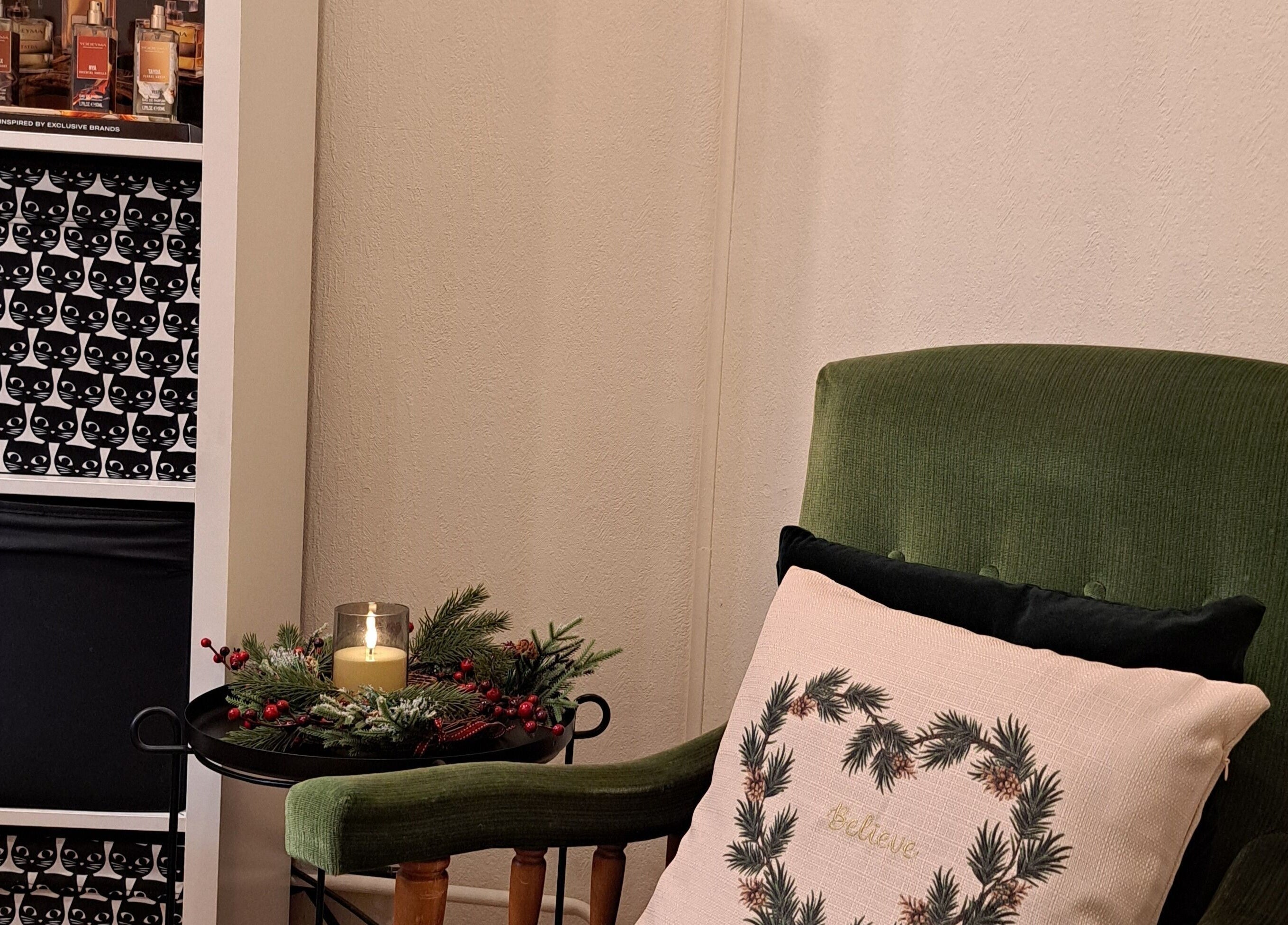 Relaxing corner at Nails & Pearls Manikīra studija in Rīga, LV with a green chair and festive decor.