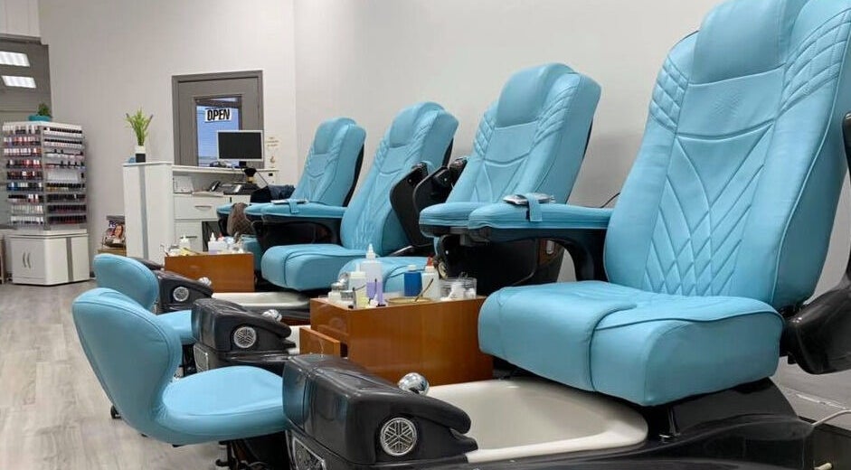 Cozy Nail & Spa in Alexandria, Virginia, US offers plush blue pedicure chairs for a relaxing experience.