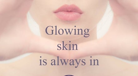 Close-up of a woman's lips with text 'Glowing skin is always in' at Bronzed Beauty, Bournemouth, England, GB.